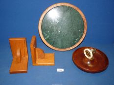A green circular marble stand set in cedar (13" diameter),