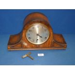 An Oak finished Napoleon's hat shaped mantle clock with Westminster chimes, with key and pendulum,