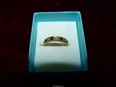 An 18ct gold Diamond and Sapphire half Eternity ring, size M.