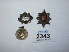 A regimental brooch with the motto 'Honi soit qui mal y pense', a St.