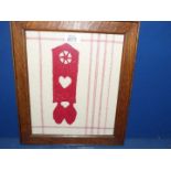 A framed tapestry of a Welsh Love Spoon (vintage frame).