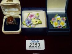 A Sterling 925 silver ring with amber stone and two English bone china brooches.
