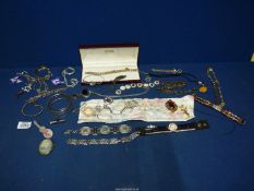 A box of miscellaneous jewellery including ten brooches, bangles, white metal bracelets etc.