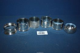 Five assorted Silver napkin rings, some engraved with monograms and flowers,