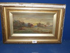 A framed Oil on canvas depicting cottages and a village church, signed lower right 'Grace Grinham'.