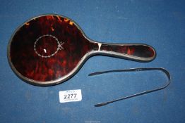 A silver and tortoiseshell handled hand Mirror (handle a/f) and a pair of silver sugar tongs.