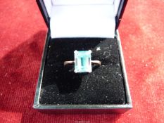 An 18ct Platinum ring, set with emerald cut aqua marine stone, size M.