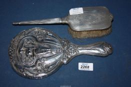 A Silver Art Nouveau hand mirror depicting a woman holding a lyre surrounded by flowers,