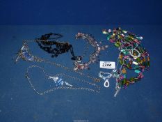A quantity of costume jewellery including multi-coloured beads, etc.