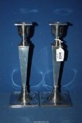 A pair of elegant Silver Candlesticks with Greek Key decoration and square tapering stems on square