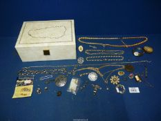 A cream jewellery box and contents including 9ct gold signet ring, Scottish silver cross brooch,