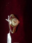 A ladies Accurist Anti-Magnetic 21 jewel gold cased Wristwatch on expanding bracelet.