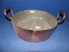 A copper dish with handles (repair to base).