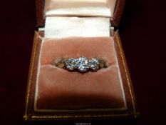 An 18ct gold, three stone Diamond ring, size Q (3g).