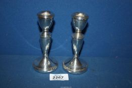 A pair of Silver candlesticks, Birmingham 1975, maker Bishton's Ltd. 5" tall.