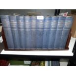 Ten volumes of The Children's Encyclopedia on a Bakelite book stand.