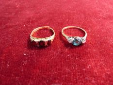 Two 18ct gold rings, one set with a diamond either side of an aqua marine ((2g) badly scratched),