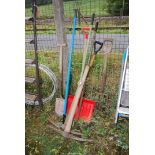 Two pick axes, snow shovel, spade and fork.
