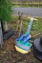 A garden sprayer, garden tools and a water gun.