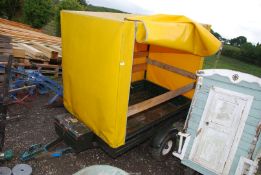 A covered trailer on indispension axle on Mini 10" wheels having zip opening tarpaulin and a spare