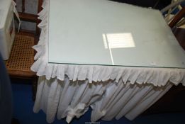 A glass top dressing table with embroidery Anglais valance