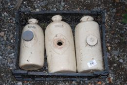 Three china hot water bottles - (one with top missing).