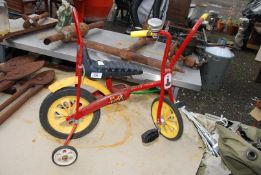 A child's Raleigh Chippy bike with stabilisers.