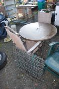 A round patio table with two chairs, plus a galvanised mesh pen.