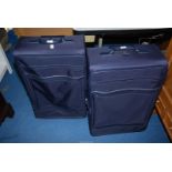 Two large blue suitcases.