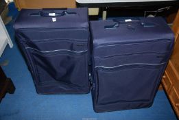 Two large blue suitcases.