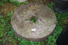 A grindstone, 18" diameter x 4" wide.
