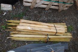 A quantity of round stakes, 47" long and some wooden slats, 33" long.