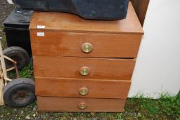 A three drawer chest of drawers, 25" wide x 15" deep x 29" high.