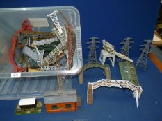 A tub of model railway scenery including fences, platforms, etc.