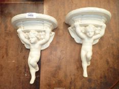 Two Cherub corbels, chips to back of rim, 12" high.