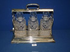 A plated Tantalus by Walker & Hall with set of three cut glass Decanters (some chips),