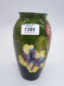A Moorcroft vase in Hibiscus pattern. 7 1/4" tall.
