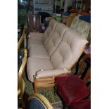 An Ercol three seater Settee with red spotted beige upholstered cushions.