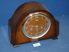 A darkwood 'Smith Enfield' Clock with key, 11" wide x 8" high x 4" deep.