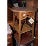 An octagonal Oak occasional Table having fretwork details the legs united by a lower shelf,