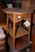An octagonal Oak occasional Table having fretwork details the legs united by a lower shelf,