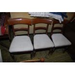 Three Mahogany framed circa 1900 side Chairs standing on turned front legs and having cream