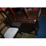 An Oak, drop-leaf gateleg Dining Table standing on turned legs united by turned stretchers,