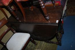 An Oak, drop-leaf gateleg Dining Table standing on turned legs united by turned stretchers,