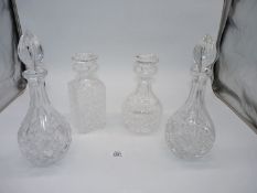 A pair of matching cut glass decanters and two Stuart cut glass decanters.