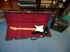 A Squire Stratocaster electric guitar by Fender in a lined hard case alongwith a Park model G10