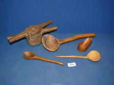 An unusual hand Juicer and various wooden Spoons (some worm damage).