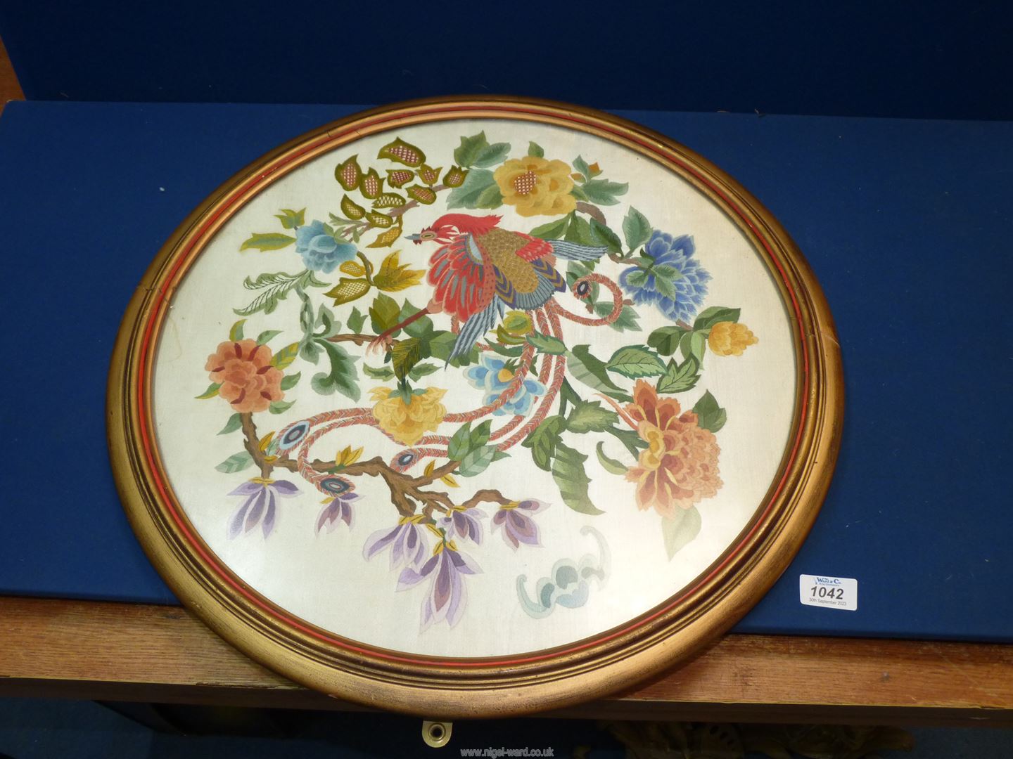 A circular framed Embroidery depicting Chinese style bird of paradise and flowers. - Image 2 of 2