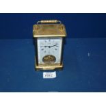 A Schatz brass Carriage clock with white face, 5 1/4'' high x 3 1/4'' wide x 2'' deep.