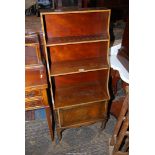 An unusual Mahogany Waterfall three tier Bookshelves having a cupboard below and decorated with